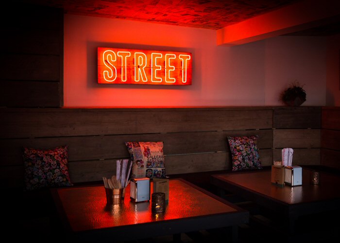 STREET' amber neon sign. Real glass neon fitted onto reclaimed wooden panel.