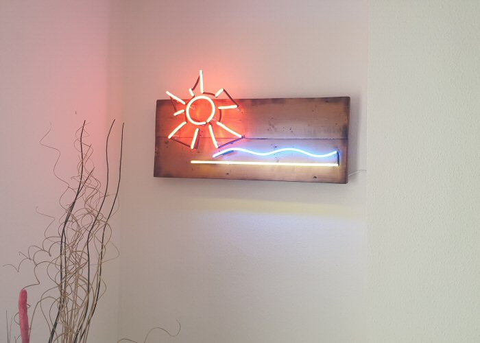Sun, sea and beach' multi-coloured neon sign. Real glass neon mounted on to reclaimed wooden panel.