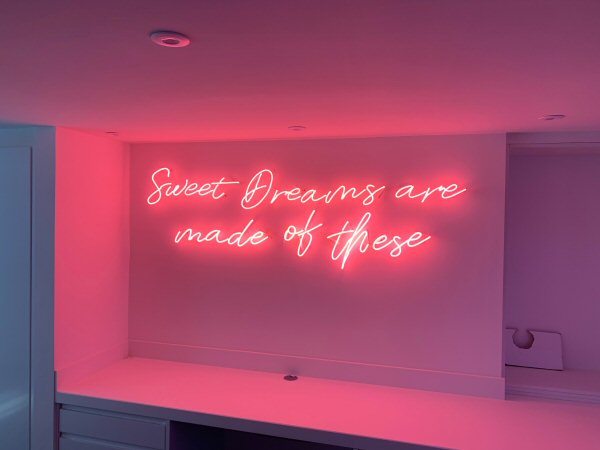Sweet dreams are made of these' pink neon sign. Real glass neon fitted directly onto wall.