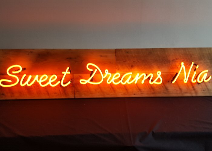 sweet dreams' orange neon light. Real glass neon mounted directly onto wall.