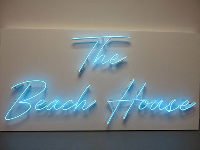 The Beach House' blue neon sign. Real glass neon fitted onto white acrylic panel.