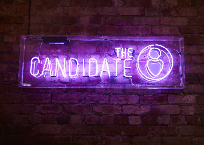 THE CANDIDATE' purple neon sign. Real glass neon fitted inside clear acrylic case.