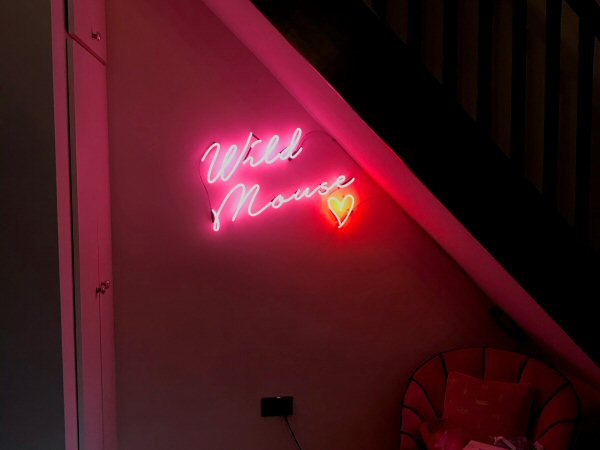 Wild Mouse' pink and red neon sign. Real glass neon fitted directly onto wall.