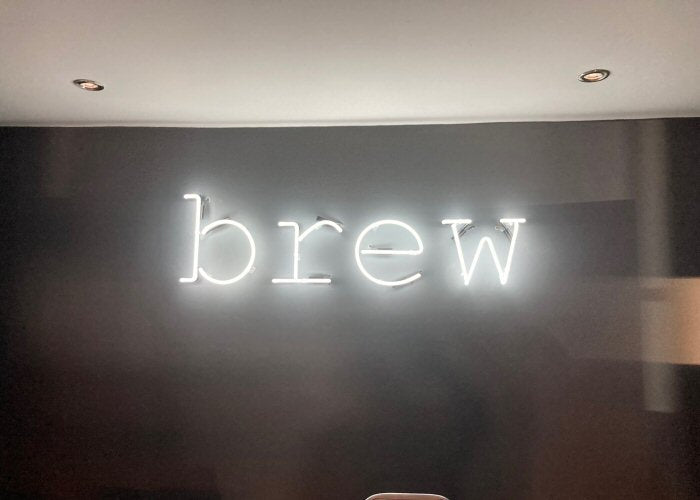 Brew?' orange neon sign. Real glass neon fitted directly onto wall.