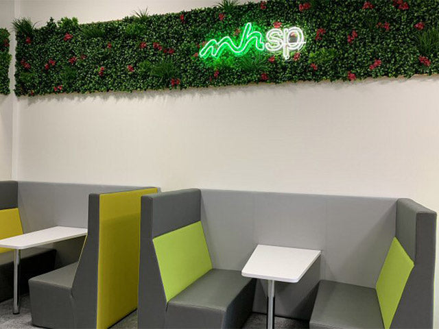 mhsp' green and white neon sign. Real glass neon fitted onto artificial foliage.