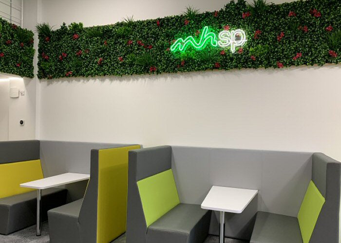 mhsp' green and white neon sign. Real glass neon fitted onto artificial foliage.