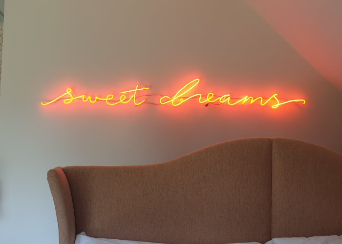 sweet dreams' orange neon light. Real glass neon mounted directly onto wall.
