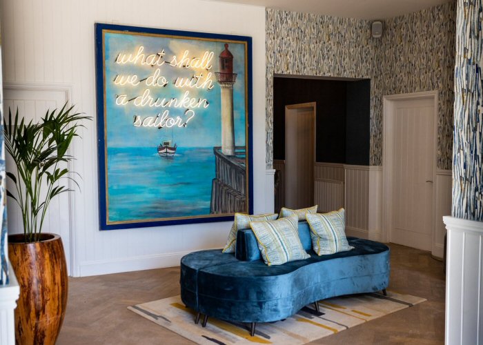 what shall we do with a drunken sailor?' white neon sign. Real glass neon fitted onto clients own backing panel.