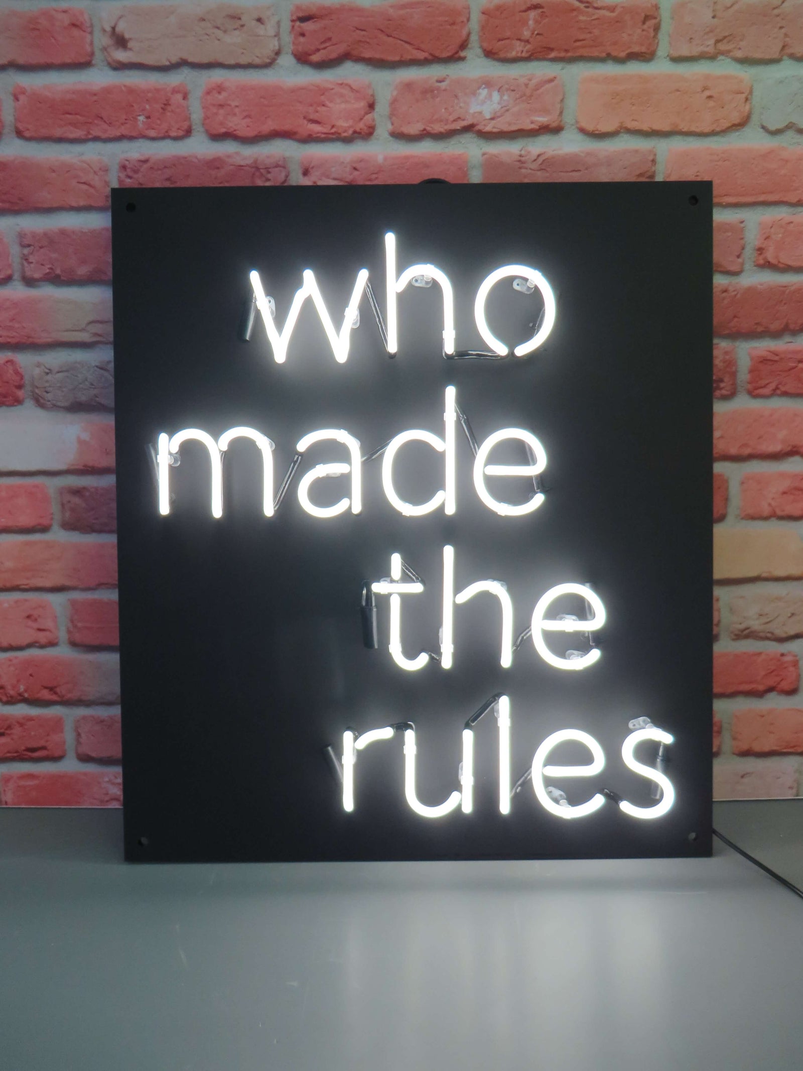 who made the rules' white neon sign. Real glass neon fitted directly onto satin black acrylic panel.